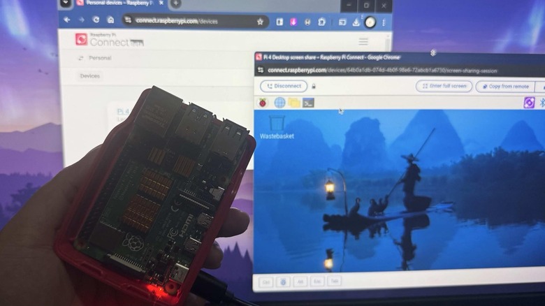 Hand holding active Raspberry Pi with Raspberry Pi Connect sessions in the background