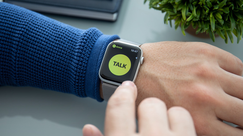 Man's arm wearing Apple Watch showing the Walkie-Talkie push-to-talk button