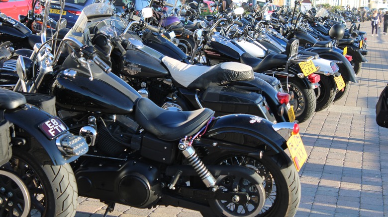 Outlaws Motorcycle Club members' Harley-Davidson bikes parked on a sidewalk