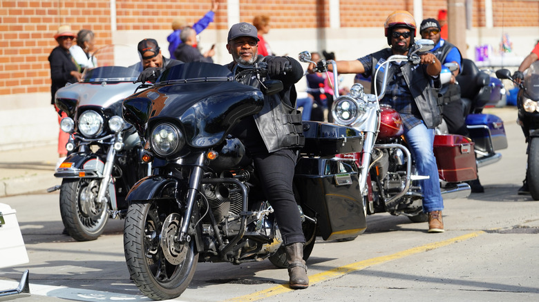 bikers on motorcycles riding together on the road