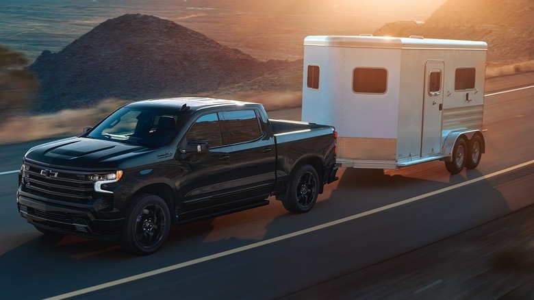 The Chevrolet Silverado 1500 High Country trim with an attached trailer.