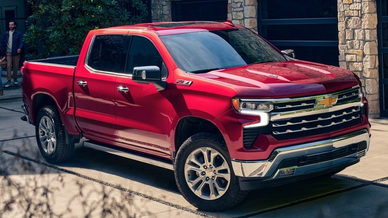 The Chevrolet Silverado 1500 in red parked on a driveway