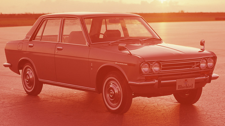 A 1970 Datsun Bluebird 1600 at sunset, front-right three-quarter view.