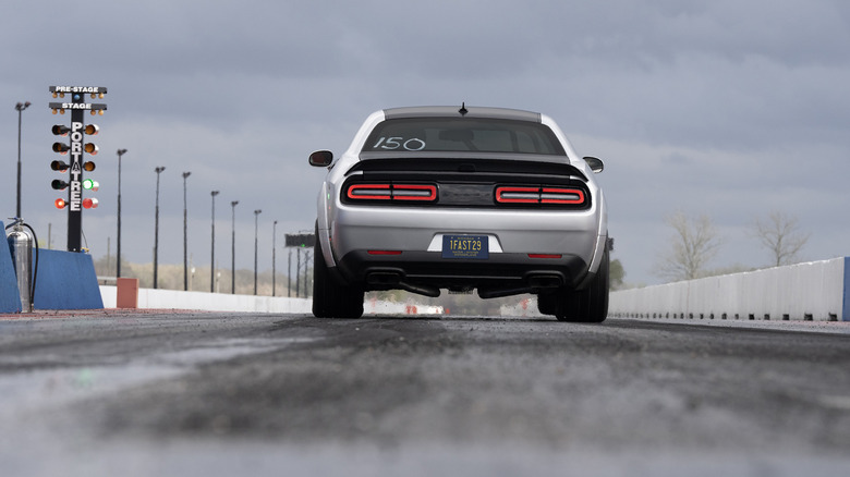 Dodge Challenger SRT Demon 170 lining up at drag strip, rear view at road at road level