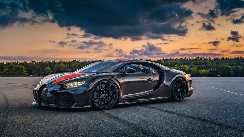 Bugatti Chiron Super Sport 300+ parked in front of row of trees at sunset