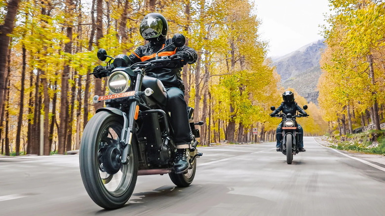 Two Harley-Davidson X 440s with riders on road