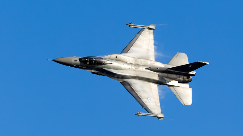 A Block 70/72 F-16 Falcon flying against a blue sky