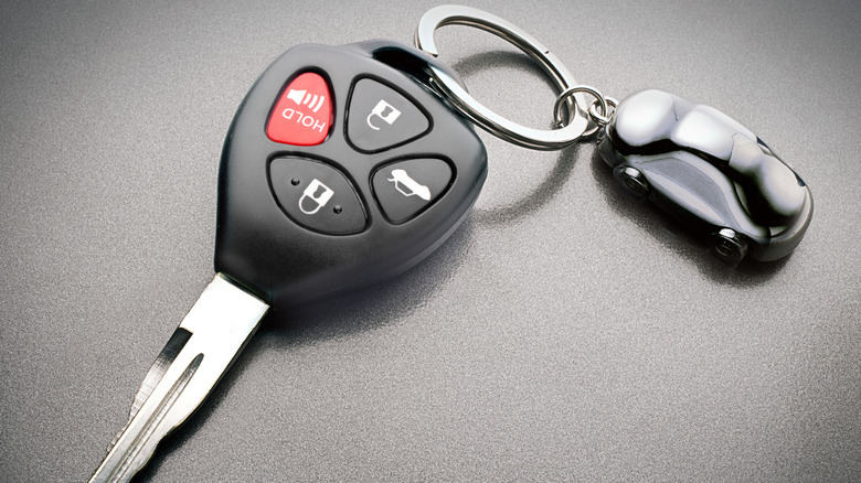 A car key fob featuring various buttons.