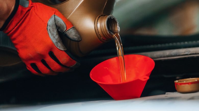 Motor oil being poured into a car