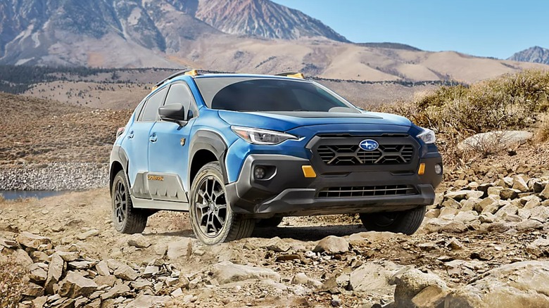 A 2024 Subaru Crosstrek parked on rocks.