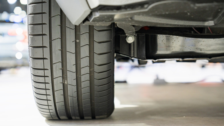 Closeup of bottom of car tire in garage