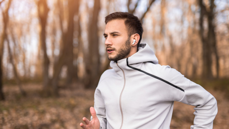 Man running and wearing wireless earbuds