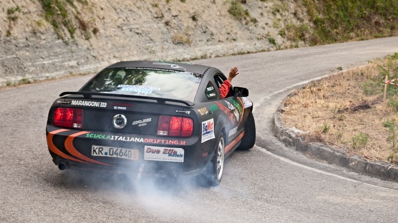 Ford Mustang spinning out in a corner rear view