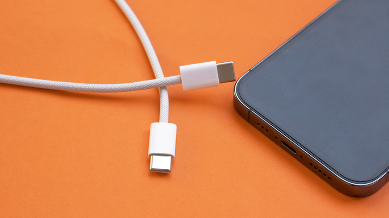 unbranded USB Type-C to USB Type-C cable next to smartphone