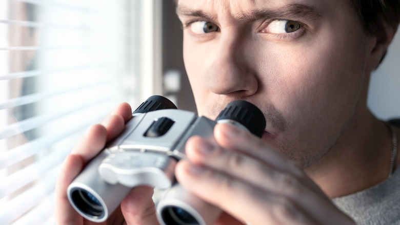 Person holding binoculars