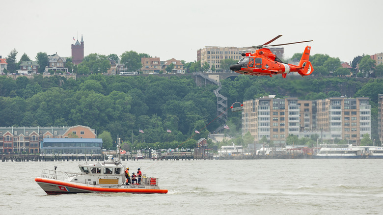 MH-65D helicopter flying above a boat