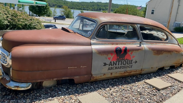 A brown Nash car parked in front of the Antique Archaeology location in LeClaire, Iowa