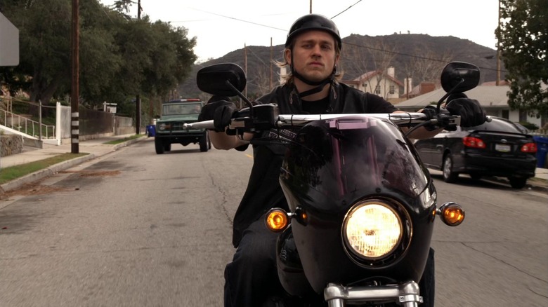 Charlie Hunnam as Jax Teller riding a motorcycle