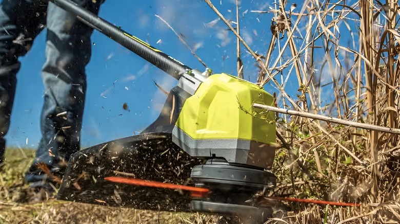 Grass trimmer cutting grass