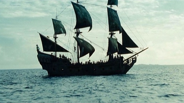 The Black Pearl on the water with its sails down.