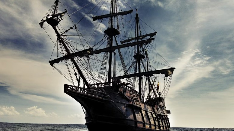 The Black Pearl on the water with its sails up.