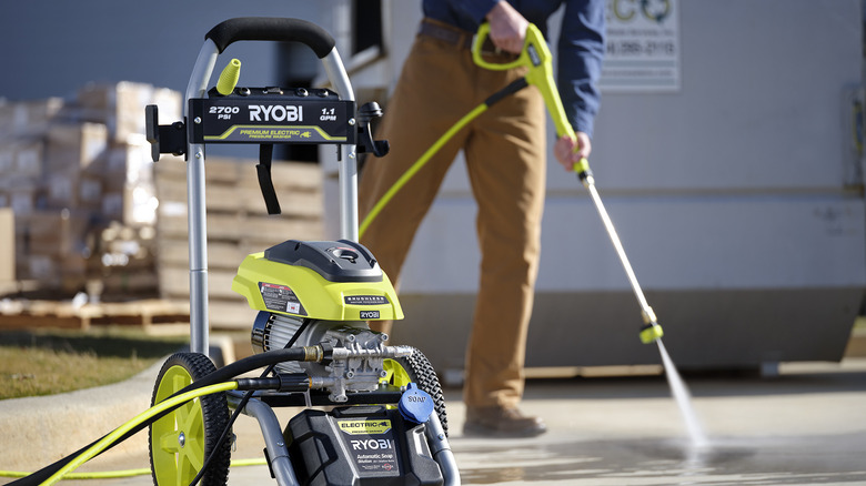 cleaning driveway with Ryobi pressure washer