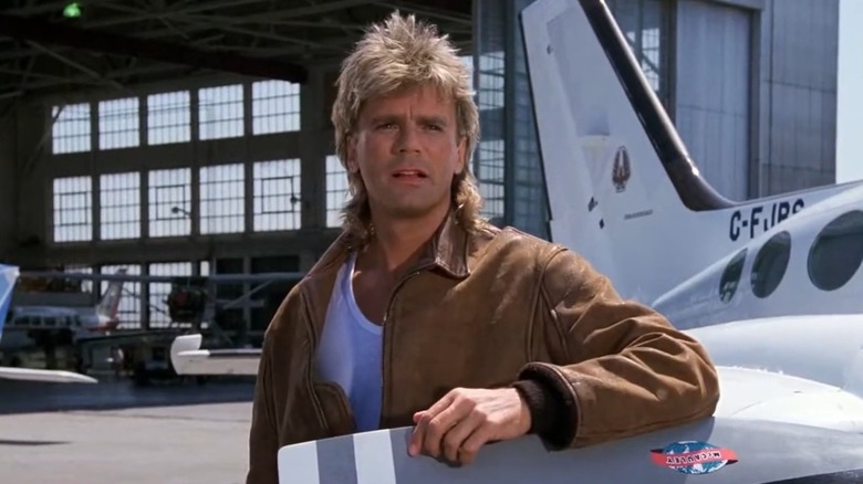 MacGyver Actor Richard Dean Anderson Next To An Aircraft In Front Of An Airplane Hanger