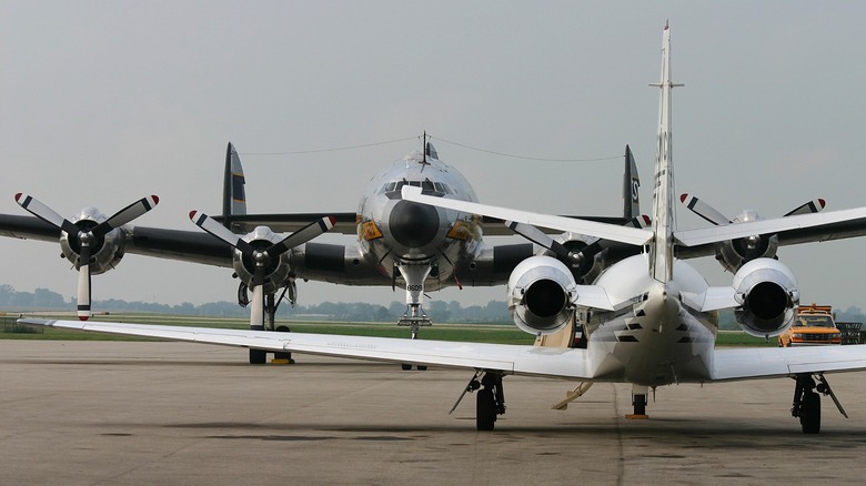 small jet next to a Lockheed Constellation