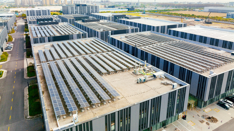 A view of several commercial roofs with solar panels