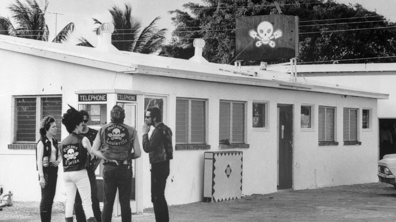 Outlaw members standing outside a clubhouse