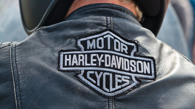 Embroidered Harley-Davidson Motor Cycles logo on the back of a biker's leather jacket