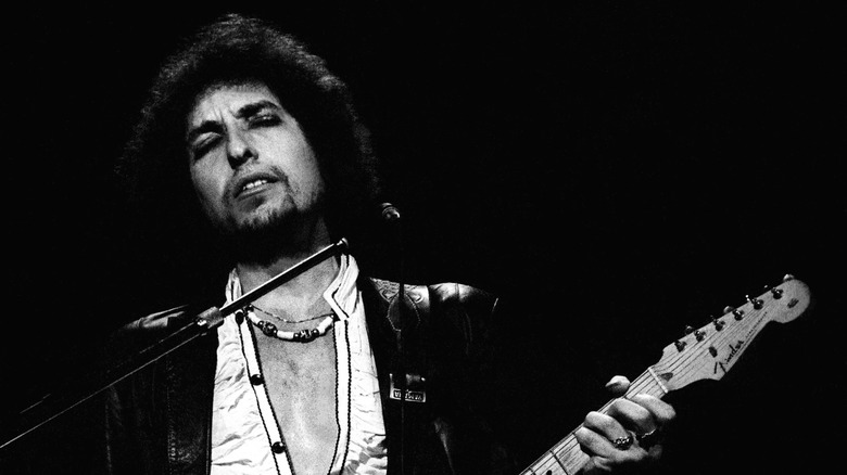 Bob Dylan on stage playing guitar in the 1970s.