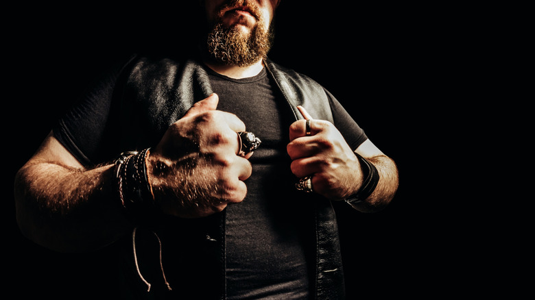 A burly biker in black T-shirt and vest