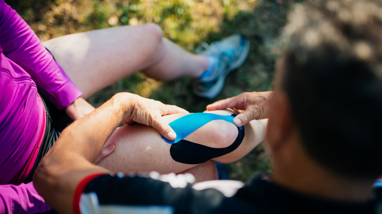 person with kinetic tape on right knee