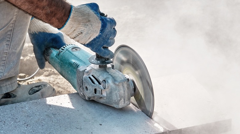 Grinder cutting through concrete