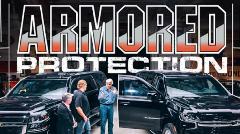 Jay Leno in front of armored vehicles