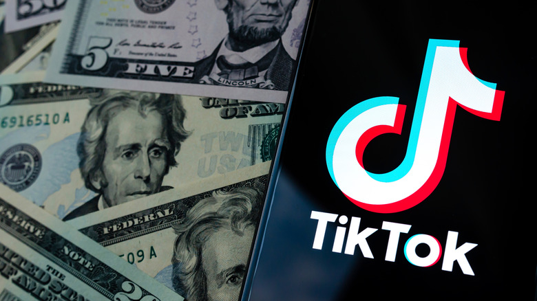 TikTok on phone and dollars