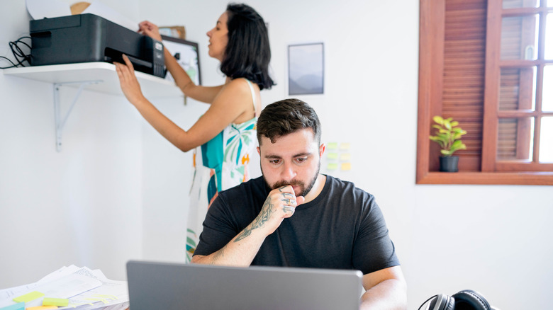 man and woman troubleshooting printer