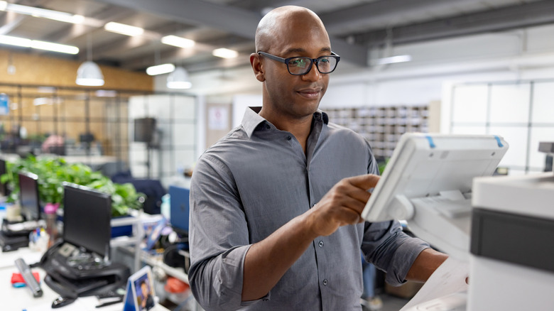 Man using workplace printer