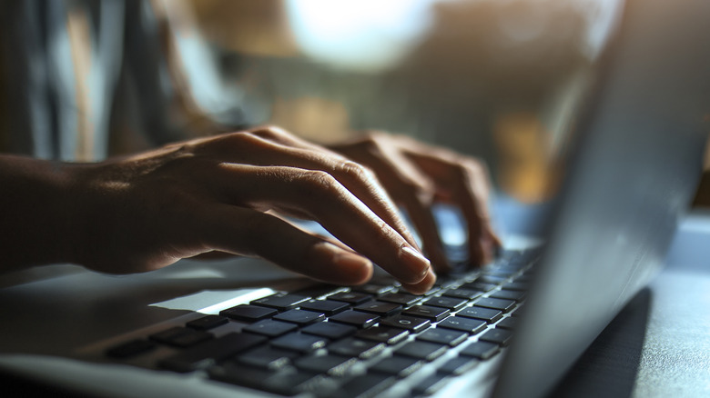 Person typing on keypad