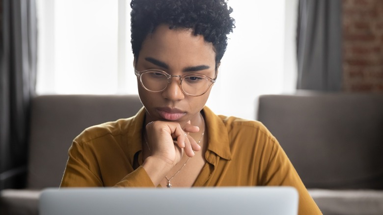 Woman staring at laptop