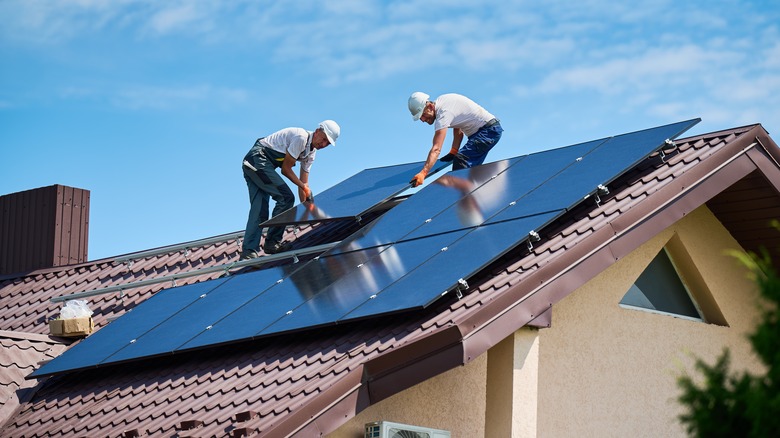 Workers installing solar panels