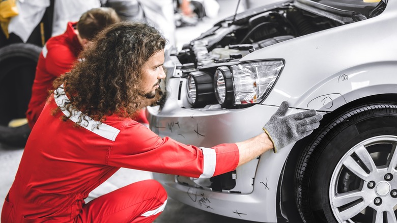 mechanic inspecting a car