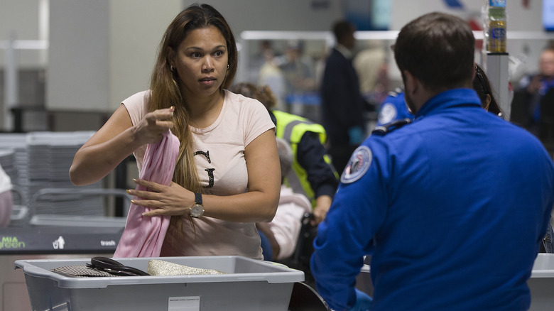 Woman looking at a TSA agent