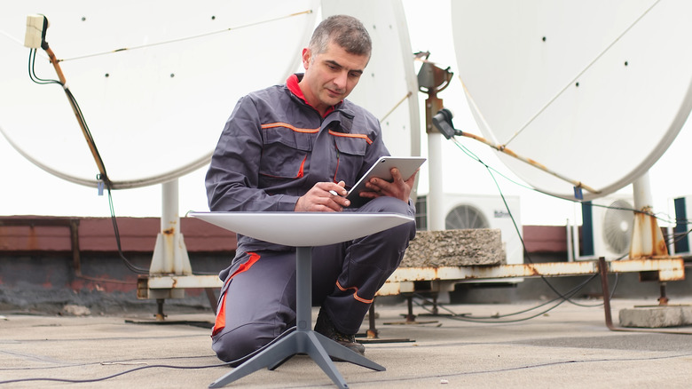 Man checking Starlink on the ground