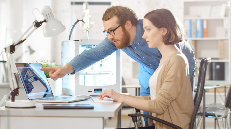 Man and woman working on computer