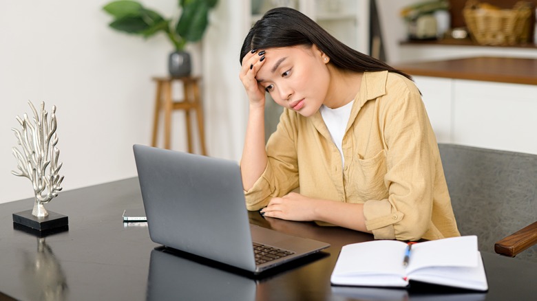 woman staring at her laptop