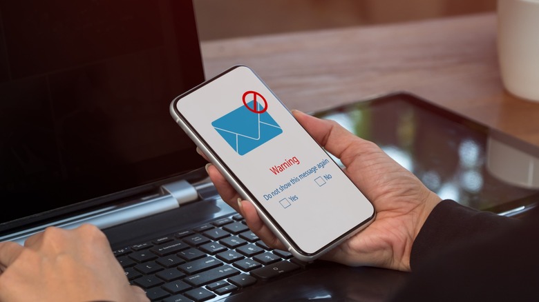 Phone displaying warning to block a message