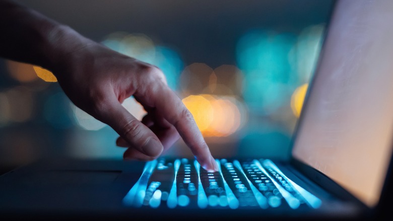 Close up of finger typing on keyboard