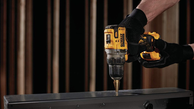 person using DeWalt drill